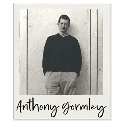 Artist category page about Sir Antony Gormley British Sculptor, polaroid picture featuring his name Antony Gormley and a photograph of him standing against one of his artworks